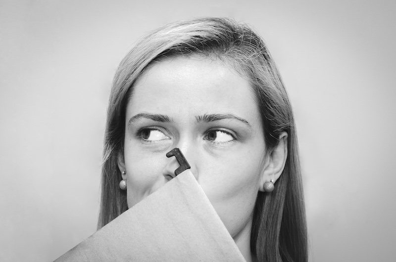 Woman hiding her mouth with a file folder