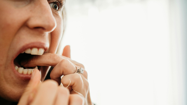 woman demonstrating flossing technique